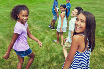 Happy, playing and portrait of children in park for walking, bonding and fun together on weekend....