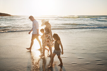 Holding hands, walking and children with parents on beach for vacation, getaway or weekend trip...