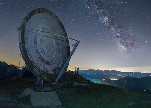 View of the abandoned troposcatter antenna at Monte Giogo under a starry night sky with the Milky Way, Toscana, Italy.