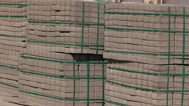 Stacked cement bricks bundled and ready for shipment at construction site