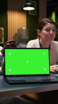 Vertical Video Mockup chroma key laptop used by office employees doing business meeting to plan project and devise strategy. Businesspeople doing research analysis with data, using notebook.