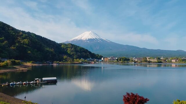 Snow-capped Mt. Fuji landscape overlooking peaceful Lake Kawaguchiko at Yamanashi Prefecture in Japan on a beautiful Spring day.