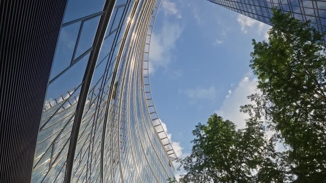 Cinematic upward camera movement between modern skyscrapers and office buildings in financial center, highlighting corporate development and city business infrastructure