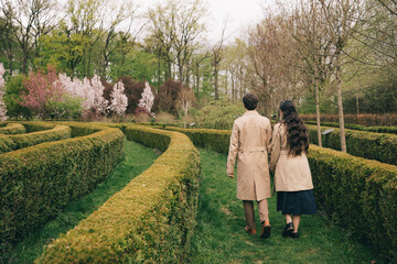Fototapeta premium Romantic Couple Walking Together In Spring Garden