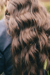 Naklejka premium Beautiful Dark Hair with Red Flower Decoration