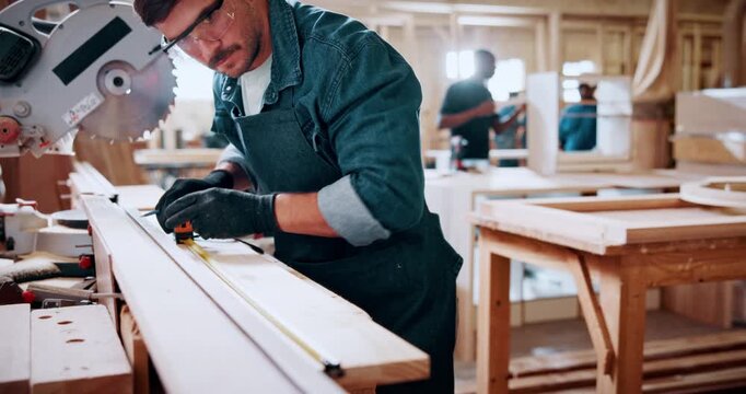 Carpentry, measure and man in workshop for manufacture, planning or project with furniture. Industry, small business and male woodworker with timber material and saw machine for production in factory