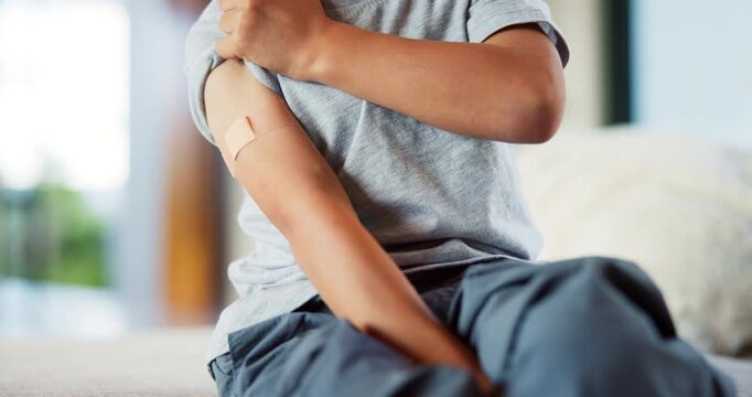 Hands, child and plaster for vaccine in home with medicine, flu shot or healthcare for illness. Kid, bandage and cover for injection, wellness and boost for immune system, virus or safety at house