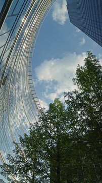 Cinematic urban scene featuring modern glass buildings and dynamic camera movement in corporate district, ideal for themes of business and city growth