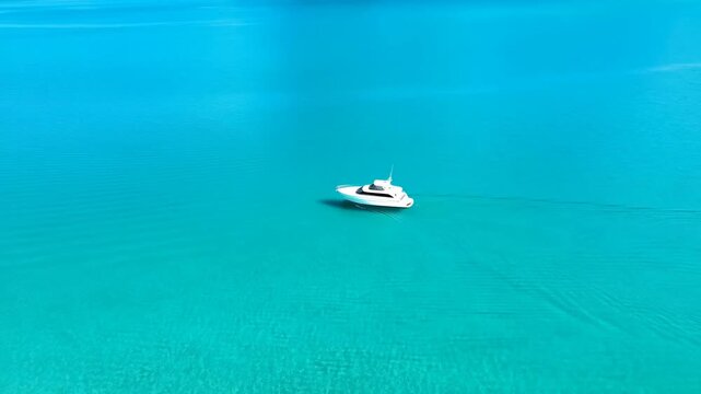 Aerial view of luxury yacht in turquoise tropical water