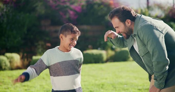 Fist bump, love and smile with father and son outdoor for bonding, support and connection. Happiness, handshake and trust with man and child in backyard of family home for commitment and achievement