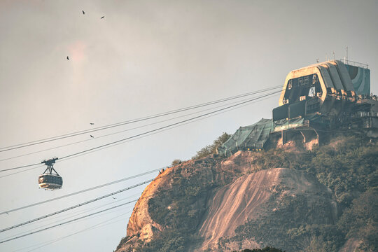 View of the Sugarloaf Mountain cable car ascending towards the summit station over the rocky cliffs Rio de Janeiro, State of Rio de Janeiro, Brazil.