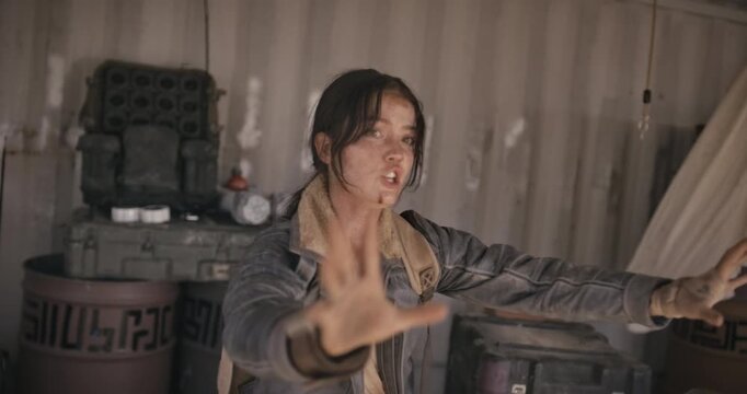 Beat up, dirty woman cornered in shed and holding up hands - steady cam movement shot