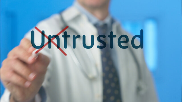 Doctor's hand highlighting and crossing out untrusted word on a transparent screen, symbolizing a rejection of fraudulent or unreliable medical advice and promoting trustworthiness