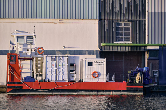 Wormer, Netherlands - 06 May 2026: View of the ofi cocoa factory De Moriaan with an electric pusher tug docked at the quay along the Zaan river.