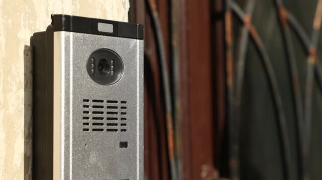 Modern intercom system on building outdoors, closeup. Camera moving up