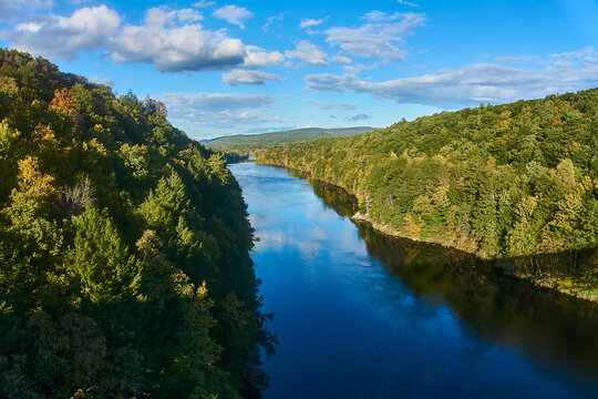 The Connecticut river going through a valley in early fall. 