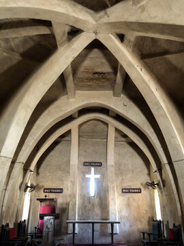 Zaria, Nigeria - 22 March 2026: View of the interior of St Bartholomew's Church in Wusasa featuring unique vaulted mud arches and a glowing cross-shaped window.