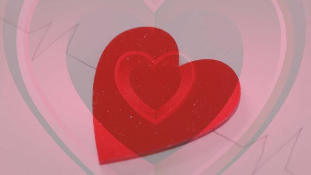 On play red heart rotating and settling while translucent heart pulsing, forming greeting-card loop