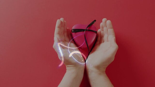Glowing line appearing above cupped hands holding heart box, tracing loops, sparking, showing gift