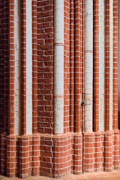 Bad Doberan, Germany - 19 July 2025: View of the red brick masonry and white vertical columns inside the Doberaner Munster, a masterpiece of Brick Gothic architecture.