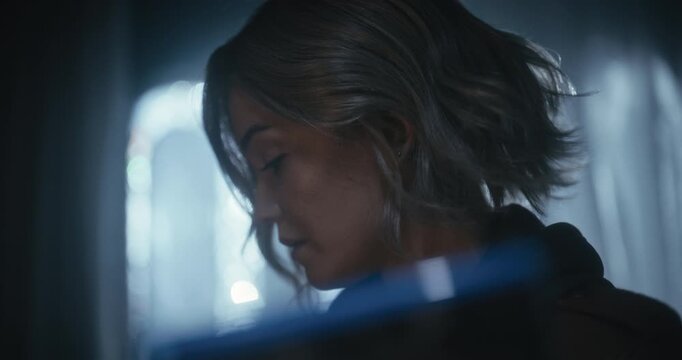 Cinematic silhouette of woman staring at something while she answers old rotary phone - closeup