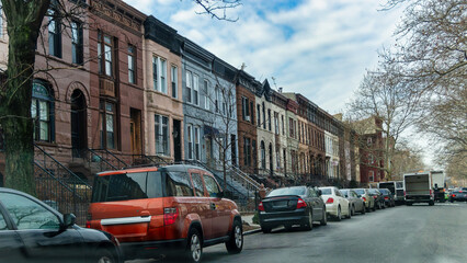 Fototapeta premium New York, US, 15 January 2015 Row Houses and Parked Cars Along an Urban Residential Street