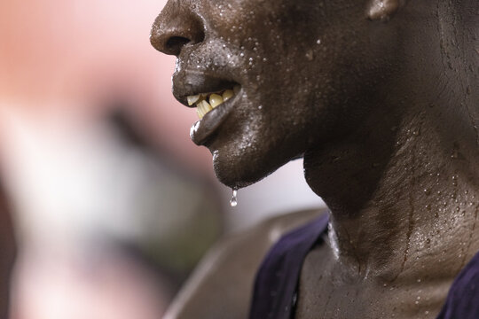 Nairobi, Kenya - 24 April 2026: View of a sweating athlete at Nyayo National Stadium with water droplets on the skin and a purple jersey during a sporting event.