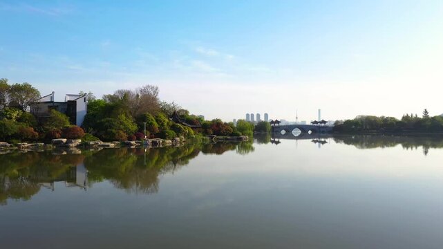 Scenic Xuanwu Lake Park with arched bridge and Nanjing skyline in Xuanwu Lake Park, Nanjing, China