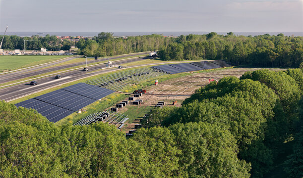 Den Oever, Netherlands - 21 May 2026: Aerial view of solar park construction on the embankment of the A7 highway near the Stevin Sluices as part of the Afsluitdijk renewal project.