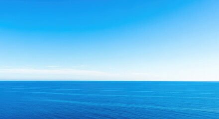 Fototapeta premium Wide open shot of a vibrant blue sky meeting the deep blue ocean water at a perfect, uninterrupted horizontal line, separation, negative space, backdrop
