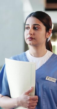Surgeon, woman or serious discussion with folder in clinic for treatment fail, health mistake or warning. Walking, frustrated doctor and disagreement with file for diagnostic error and incompetence