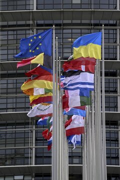 Ukrainian and EU flag in the wind in front of the European Parliament, Louise Weiss Building, Strasbourg, D&eacute;partement Bas-Rhin, Alsace, France