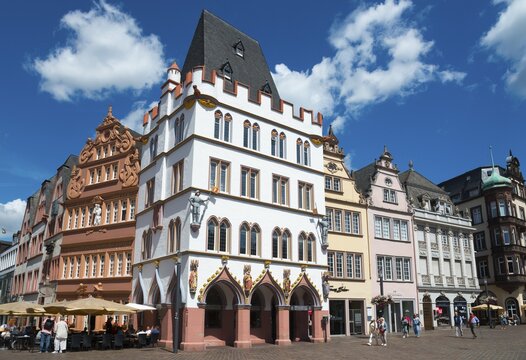 Historic old town with half-timbered houses, blue sky and caf&eacute;s, animated by tourists under summer sunshine, in the centre Haus Steipe with arcade and battlements, Hauptmarkt, Trier, Rhineland-Palatinate, Germany