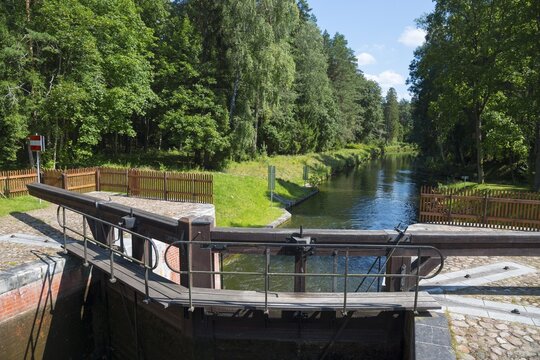 Wooden mechanism of the lock on the waterway through a green forest area, Śluza Perkuć, Perkuc lock, Kanał Augustowski, August&oacute;w Canal, Augustow, canal, Płaska, Plaska, Powiat Augustowski, Podlaskie Voivodeship, Poland