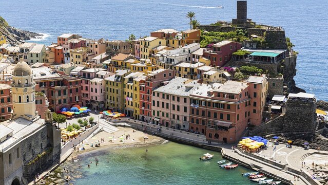 The village of Vernazza with its nested pastel-coloured houses built into the hillside, view from the Via dellAmore hiking trail, Vernazza, Cinque Terre, Ligurian Coast, Liguria, Italy