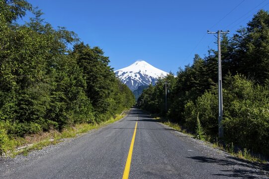 Road leading to the snowcapped volcano Villarrica, Pucon, southern Chile, Chile
