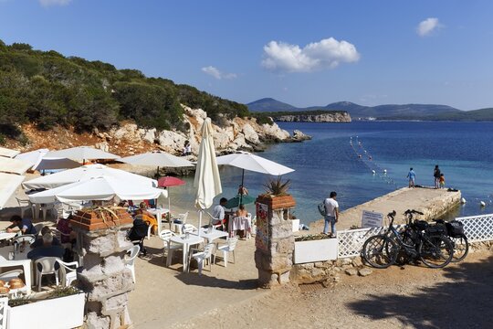 Cala Dragunara beach with beach bar, holiday on the Mediterranean, Capo Caccia headland, Porto Conte National Park, Alghero, Sardinia, Mediterranean, Italy