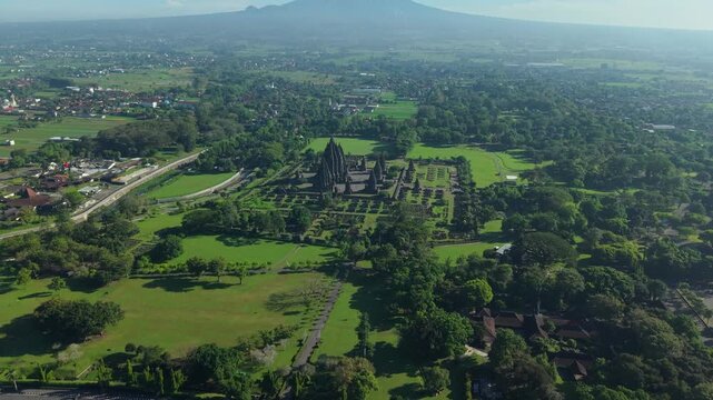 Aerial view of the ancient Prambanan Temple complex surrounded by lush green parks and tropical trees in Kecamatan Prambanan, Daerah Istimewa Yogya, Indonesia.