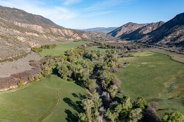 Obraz premium Aerial view of Grass Valley in Garfield County, Colorado on early spring morning under sunny diffuse cloudscape.