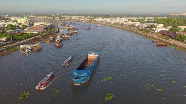 Aerial view of Cai Rang floating market. CaiRang is famous market in mekong delta, Can Tho, Vietnam. Tourists, people buy and sell food, vegetable, fruits on boat, ship. The vibrant scene, crowded