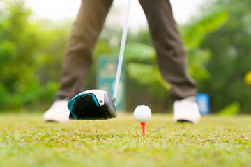 Obraz premium Golfer addressing - positioning the ball before tee off shot