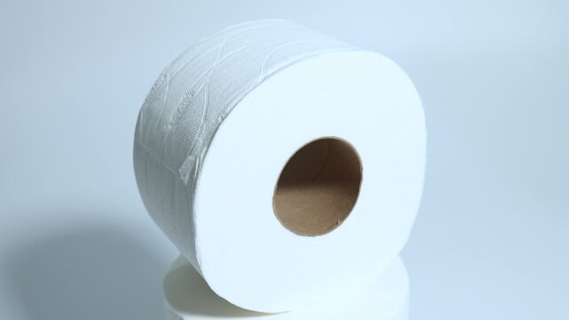 Toilet paper against a white background, shot from a rotating platform in slow motion, close up