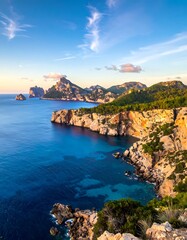 Fototapeta premium A serene coastal landscape with rugged cliffs, calm blue waters, and a clear sky