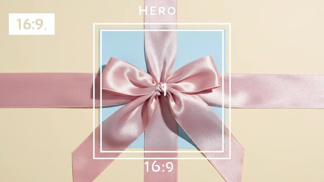 Pink satin ribbon tied in bow on blue background.