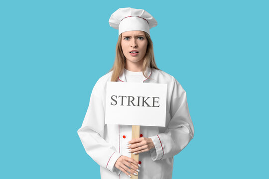 Protesting female chef holding placard with text STRIKE on blue background