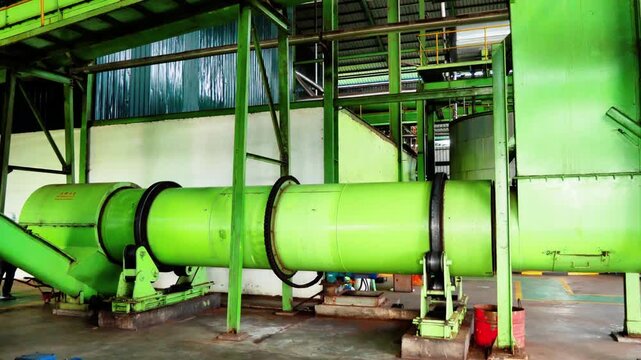 Industrial palm oil digester machine rotating in a factory, heavy machinery for palm oil extraction and refining processes in a production plant