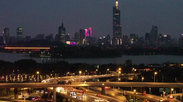 Nanjing Night Skyline with Highway Traffic and Xuanwu Lake in Nanjing, China