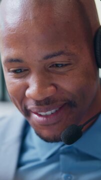 Happy man, headset and talking in call center for telemarketing, finance advice and problem solving. Black person, insurance agent and mic at computer for communication, policy FAQ and outbound calls