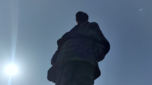 Dramatic low-angle footage of the Statue of Unity with bright sunlight and clear sky, ideal for India tourism, national pride, leadership, monument, and documentary projects.