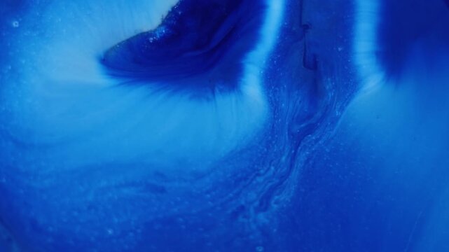 Ink flow. Pigment liquid. Blue acrylic stream mix blend. Color fizz splatter diffusion abstract emulsion spread defocused background.